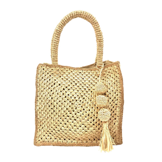 Woven straw handbag with a tassel on a white background