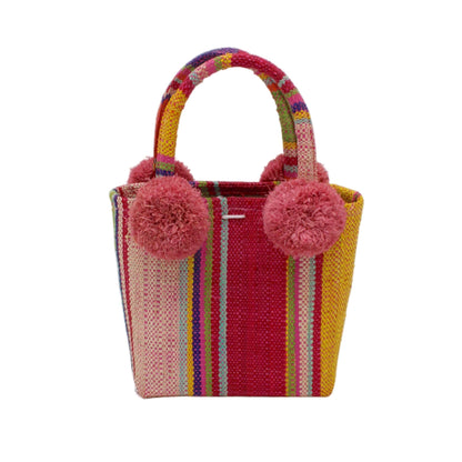 Colorful woven bag with pom-pom handles on a white background